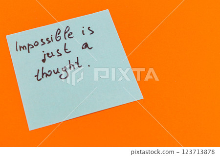 Motivational note on sticky paper against bright orange background 123713878