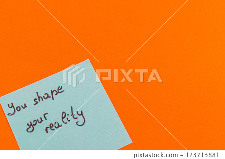 Handwritten motivational note on a vibrant orange background Handwritten motivational note on a vibrant orange background 123713881