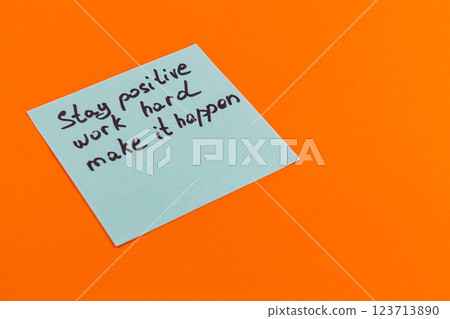 Motivational note on orange background encouraging positivity and hard work 123713890