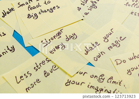Motivational notes stacked on a table for personal growth and inspiration Motivational notes stacked on a table for personal growth and inspiration 123713923