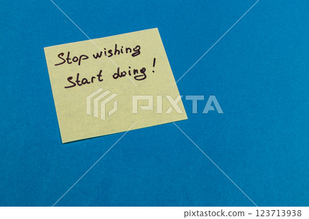 Motivational sticky note on blue background with a powerful message 123713938