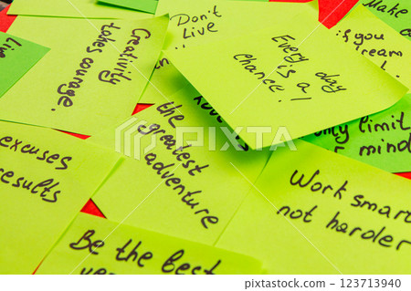 Encouraging sticky notes spread across a vibrant surface for daily motivation 123713940