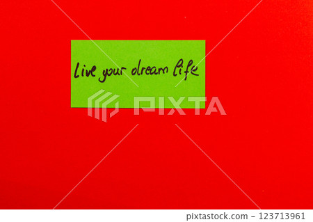 Inspiring note on colorful background encouraging you to live your dream life 123713961