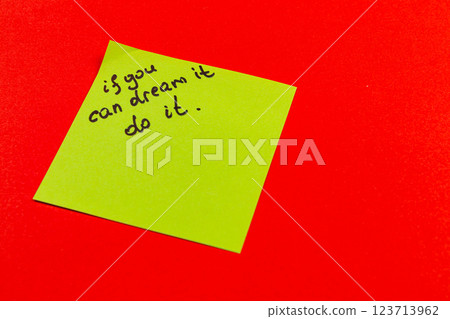 Inspirational note on bright colored background encourages action and dreams 123713962