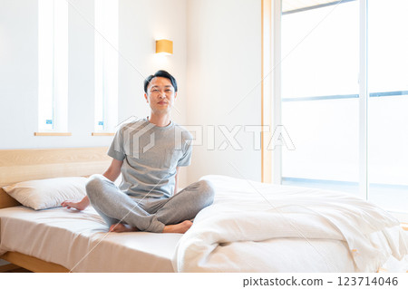 Men sitting on bed 123714046