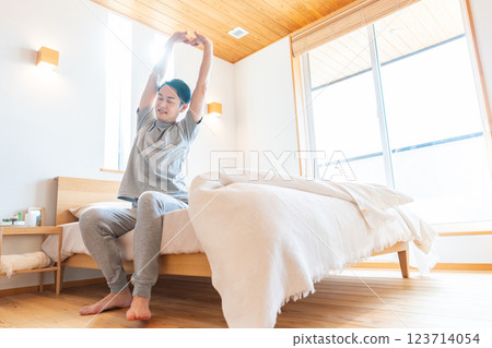 Man stretching in bed Man stretching in bed 123714054