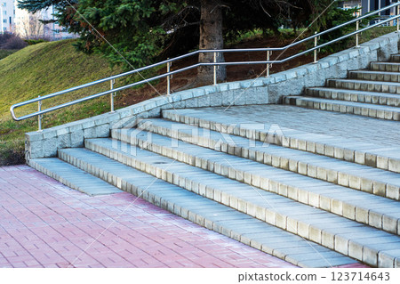 A welldesigned set of stairs featuring a sleek stainless steel railing 123714643
