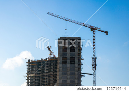A busy construction site with cranes and a building in progress 123714644