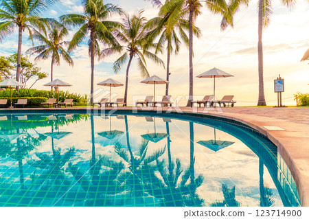 Umbrella and chair around swimming pool in resort hotel for leisure travel and vacation neary sea ocean beach 123714900