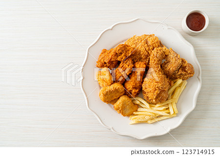 fried chicken with french fries and nuggets on plate fried chicken with french fries and nuggets on plate 123714915