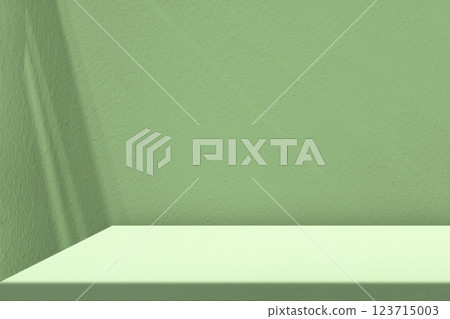 Minimal Table Corner with Shadow and Light Beam on April Green Concrete Wall Background 123715003