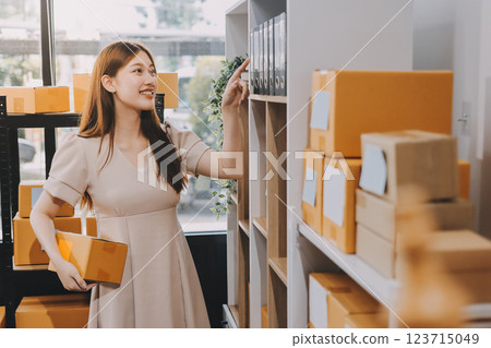 Asian SME business women use laptop computer checking customer order online shipping boxes at home. Starting Small business entrepreneur SME freelance. Online business, Work at home concept. 123715049