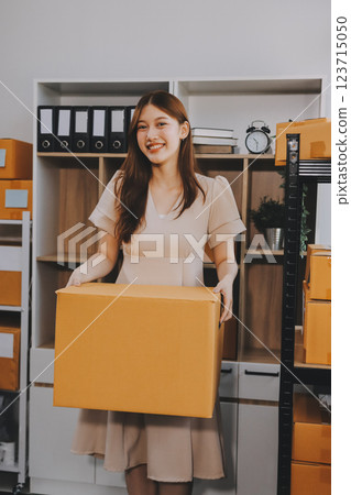 Asian SME business women use laptop computer checking customer order online shipping boxes at home. Starting Small business entrepreneur SME freelance. Online business, Work at home concept. 123715050