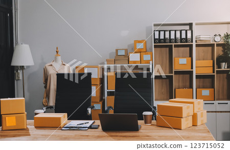 Asian SME business women use laptop computer checking customer order online shipping boxes at home. Starting Small business entrepreneur SME freelance. Online business, Work at home concept. Asian SME business women use laptop computer checking customer order online shipping boxes at home. Starting Small business entrepreneur SME freelance. Online business, Work at home concept. 123715052