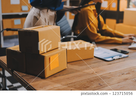 Asian SME business women use laptop computer checking customer order online shipping boxes at home. Starting Small business entrepreneur SME freelance. Online business, Work at home concept. Asian SME business women use laptop computer checking customer order online shipping boxes at home. Starting Small business entrepreneur SME freelance. Online business, Work at home concept. 123715056