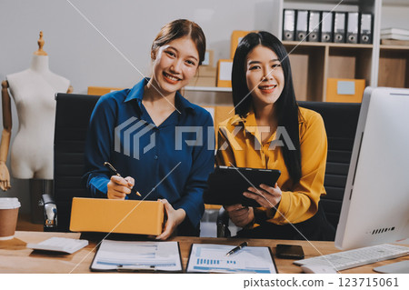 Asian SME business women use laptop computer checking customer order online shipping boxes at home. Starting Small business entrepreneur SME freelance. Online business, Work at home concept. 123715061