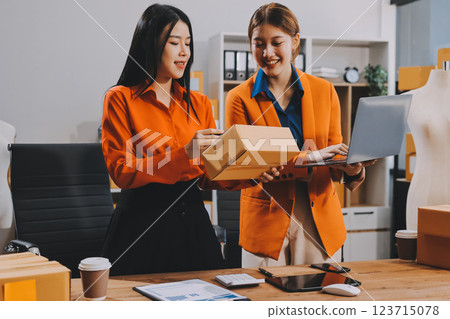 Fashion blogger concept, Young Asian women selling clothes on video streaming.Startup small business SME, using smartphone or tablet taking receive and checking in office 123715078