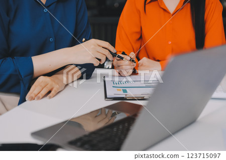 Entrepreneur Asian businessman and businesswoman discussing new business project in tablet in modern Meeting In Modern Office, Asian business casual concept. 123715097