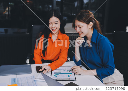 Entrepreneur Asian businessman and businesswoman discussing new business project in tablet in modern Meeting In Modern Office, Asian business casual concept. Entrepreneur Asian businessman and businesswoman discussing new business project in tablet in modern Meeting In Modern Office, Asian business casual concept. 123715098