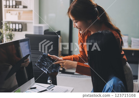 Entrepreneur Asian businessman and businesswoman discussing new business project in tablet in modern Meeting In Modern Office, Asian business casual concept. Entrepreneur Asian businessman and businesswoman discussing new business project in tablet in modern Meeting In Modern Office, Asian business casual concept. 123715108