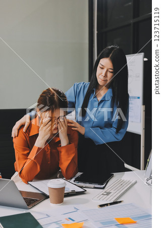 Asian women are stressed or has sore throat at office while working on laptop, Tired asian businesswoman with headache at office, feeling sick at work, copy space 123715119