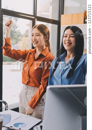 Portrait happy two young asian businesswoman standing with confident together in office, happiness two business woman arms crossed with success, coworker and friendship, business and team. 123715121