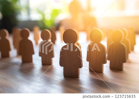 HR and business concept with a light wooden background featuring blue icons representing teamwork, success, and workplace collaboration. Abstract symbols of people and teams highlight HR and business concept with a light wooden background featuring blue icons representing teamwork, success, and workplace collaboration. Abstract symbols of people and teams highlight 123715635