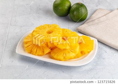 Sweet canned pineapple slices in syrope 123715826