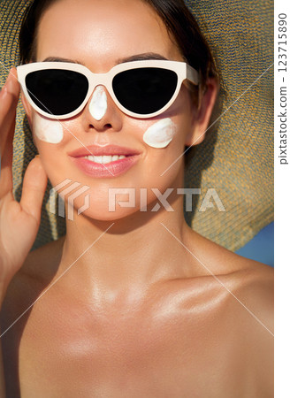 Summer Skincare Routine Featuring Sun Cream Application at the Beach for Face Protection and Radiance Summer Skincare Routine Featuring Sun Cream Application at the Beach for Face Protection and Radiance 123715890