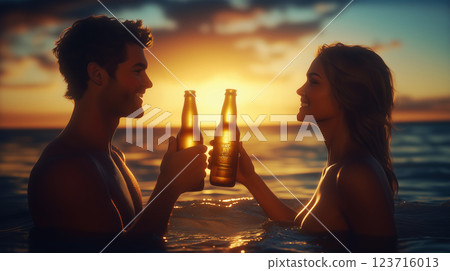 A close-up image of a man and a woman celebrating with bottles of beer clinking together. The background a ocean with the sun setting. Ai generated. 123716013