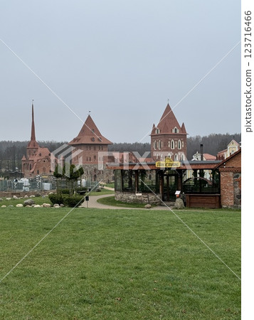 Medieval-style brick buildings with a glass-walled restaurant 123716466