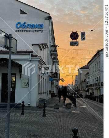 Cozy old street with sunset sky and festive lights 123716471