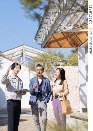 A businessman and a middle-aged couple working at a construction site 123716713