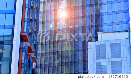 View of an modern apartment building standing next to a new modern office building with a glass facade. View of an modern apartment building standing next to a new modern office building with a glass facade. 123716850
