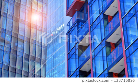 View of an modern apartment building standing next to a new modern office building with a glass facade. View of an modern apartment building standing next to a new modern office building with a glass facade. 123716856
