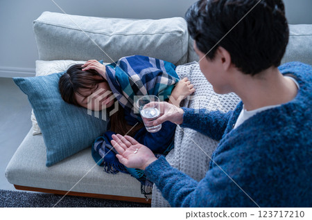 A woman who has caught a cold and is being nursed 123717210