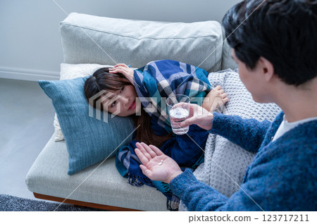A woman who has caught a cold and is being nursed 123717211