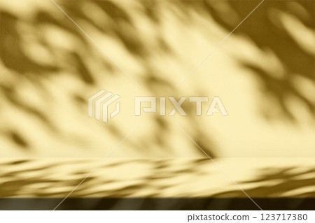 Stucco Table with Nature Shadow and Fortuna Gold Light on Concrete Wall Texture Background 123717380