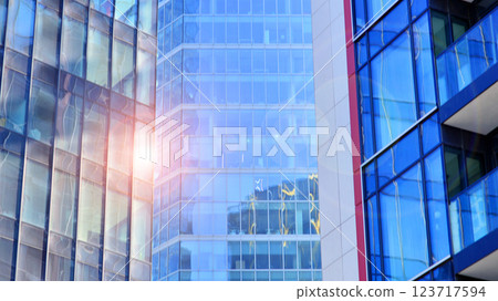 View of an modern apartment building standing next to a new modern office building with a glass facade. 123717594