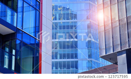View of an modern apartment building standing next to a new modern office building with a glass facade. 123717595