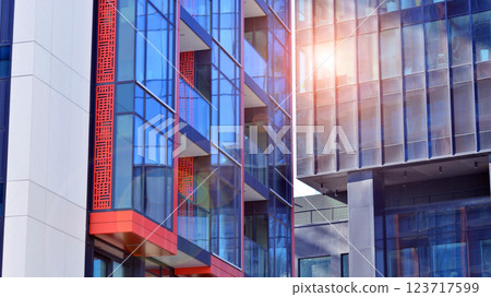 View of an modern apartment building standing next to a new modern office building with a glass facade. 123717599