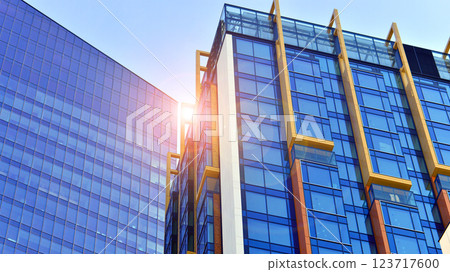 View of an modern apartment building standing next to a new modern office building with a glass facade. 123717600