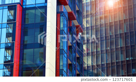 View of an modern apartment building standing next to a new modern office building with a glass facade. View of an modern apartment building standing next to a new modern office building with a glass facade. 123717601