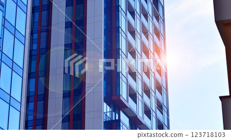 View of an modern apartment building standing next to a new modern office building with a glass facade. View of an modern apartment building standing next to a new modern office building with a glass facade. 123718103