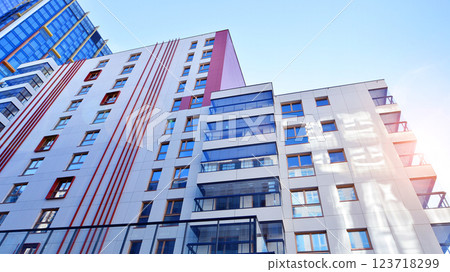 View of an modern apartment building standing next to a new modern office building with a glass facade. View of an modern apartment building standing next to a new modern office building with a glass facade. 123718299