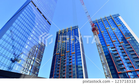 View of an modern apartment building standing next to a new modern office building with a glass facade. 123718318