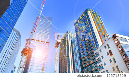 View of an modern apartment building standing next to a new modern office building with a glass facade. View of an modern apartment building standing next to a new modern office building with a glass facade. 123718319