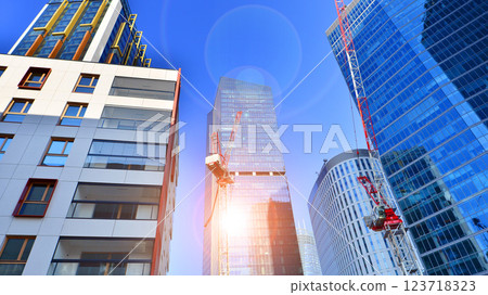 View of an modern apartment building standing next to a new modern office building with a glass facade. 123718323