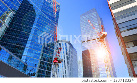 View of an modern apartment building standing next to a new modern office building with a glass facade. 123718324