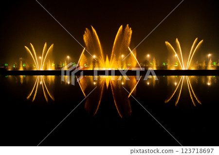 Reflection of the night light show on the water. 123718697
